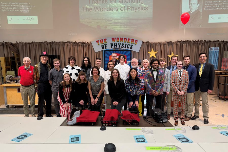 The Wonders of Physics 42nd annual show cast poses for a group picture on stage.