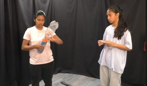 Thumbnail image showing two students demonstrating how to make a cloud in a bottle