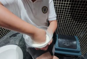 Thumbnail image from a video showing a hand punching a bowl of Non-Newtonian fluid