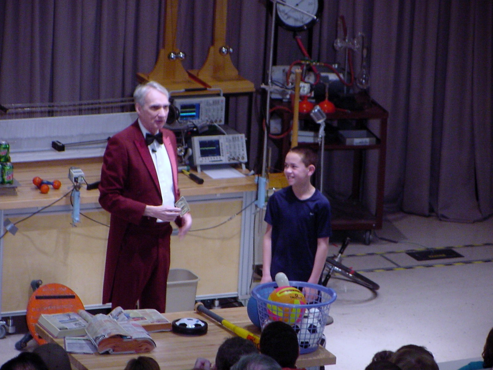 Man talking to boy on stage