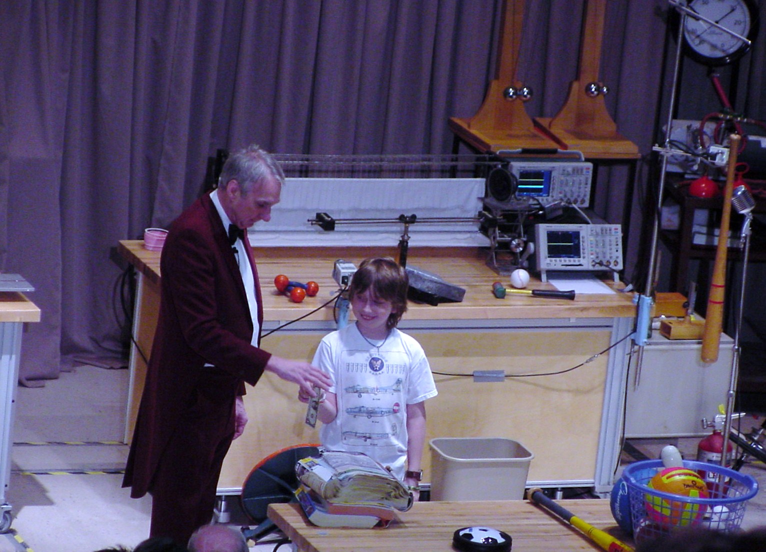 Man talking to kid on stage
