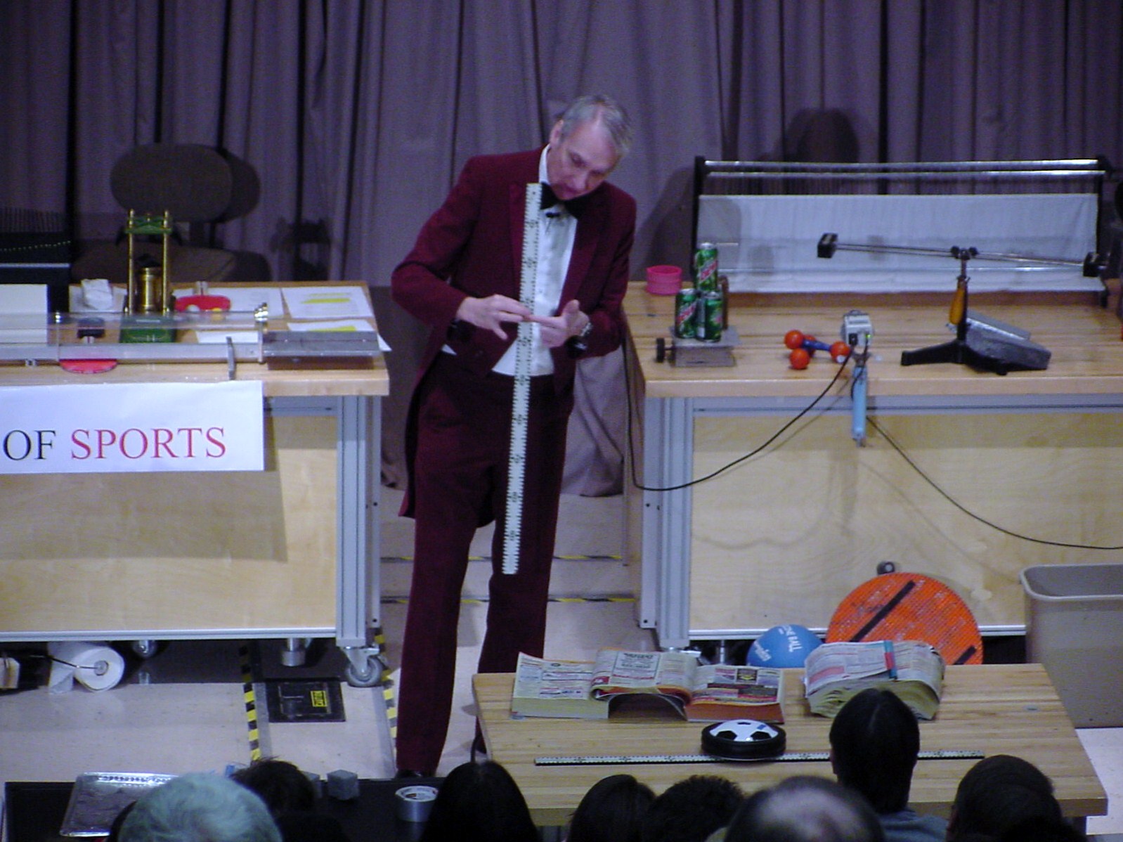 Man with ruler on stage