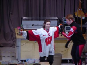Girl in UW Hockey Jersey on stage