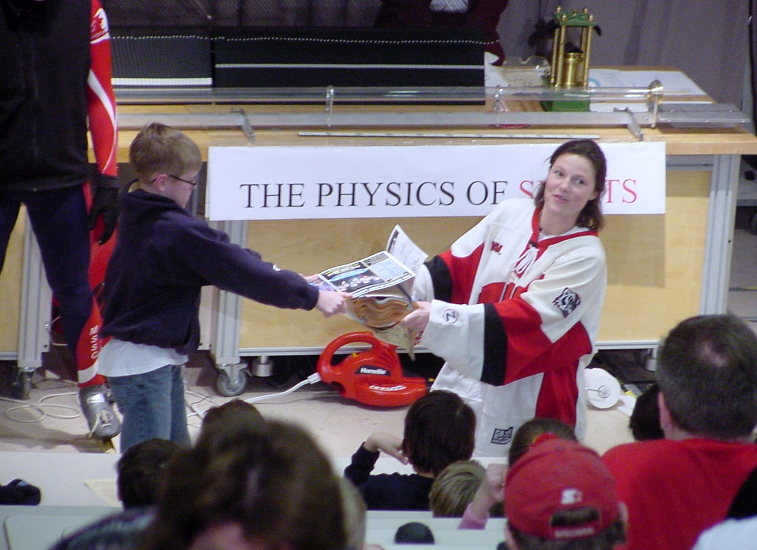 Boy and Girl pull on a book on stage
