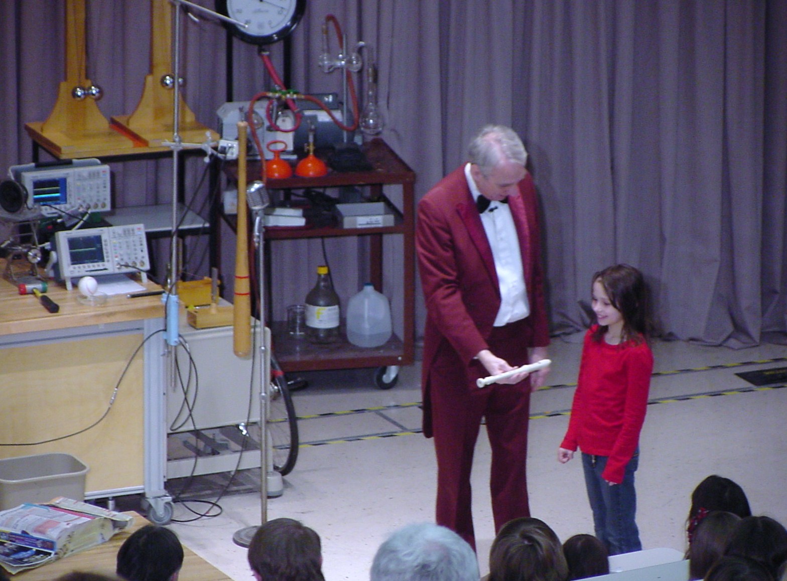 Man on stage doing an experiment