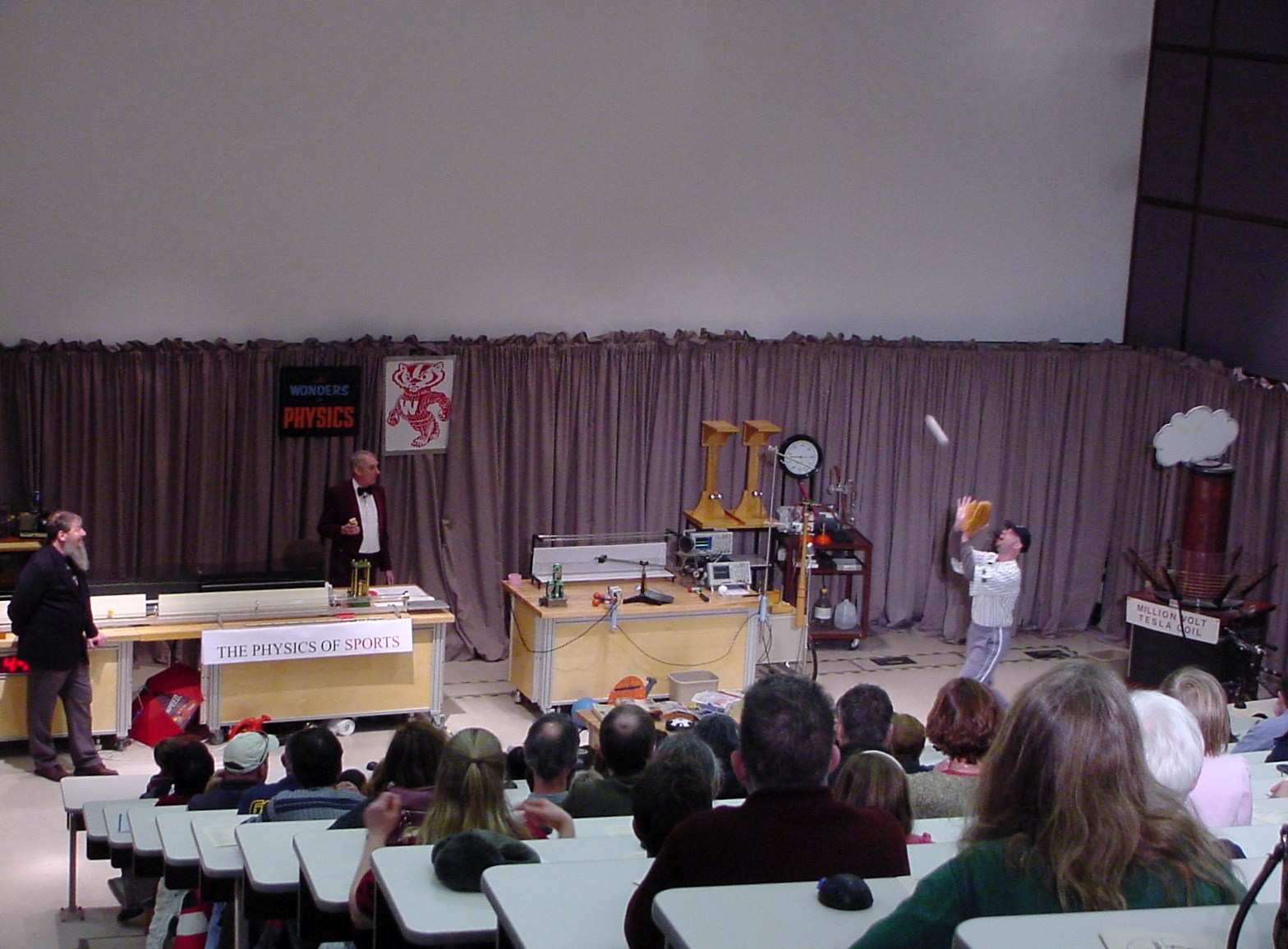 Man on stage doing an experiment