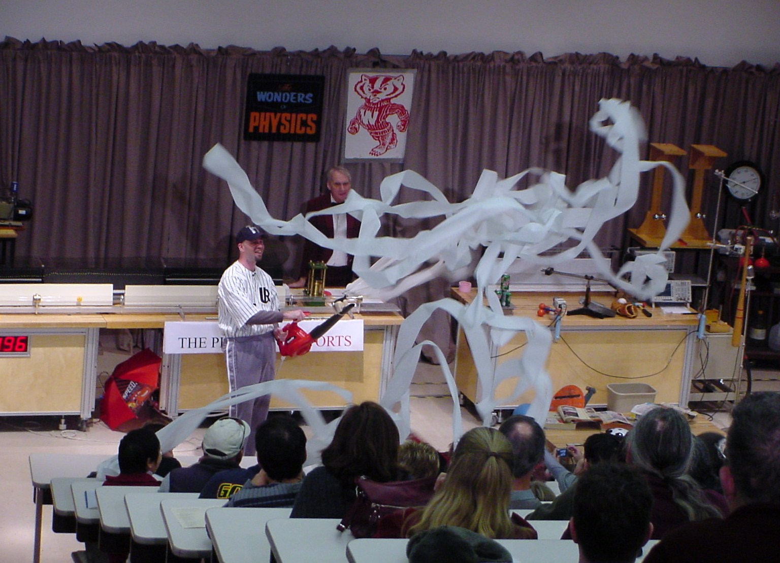 Man on stage doing an experiment