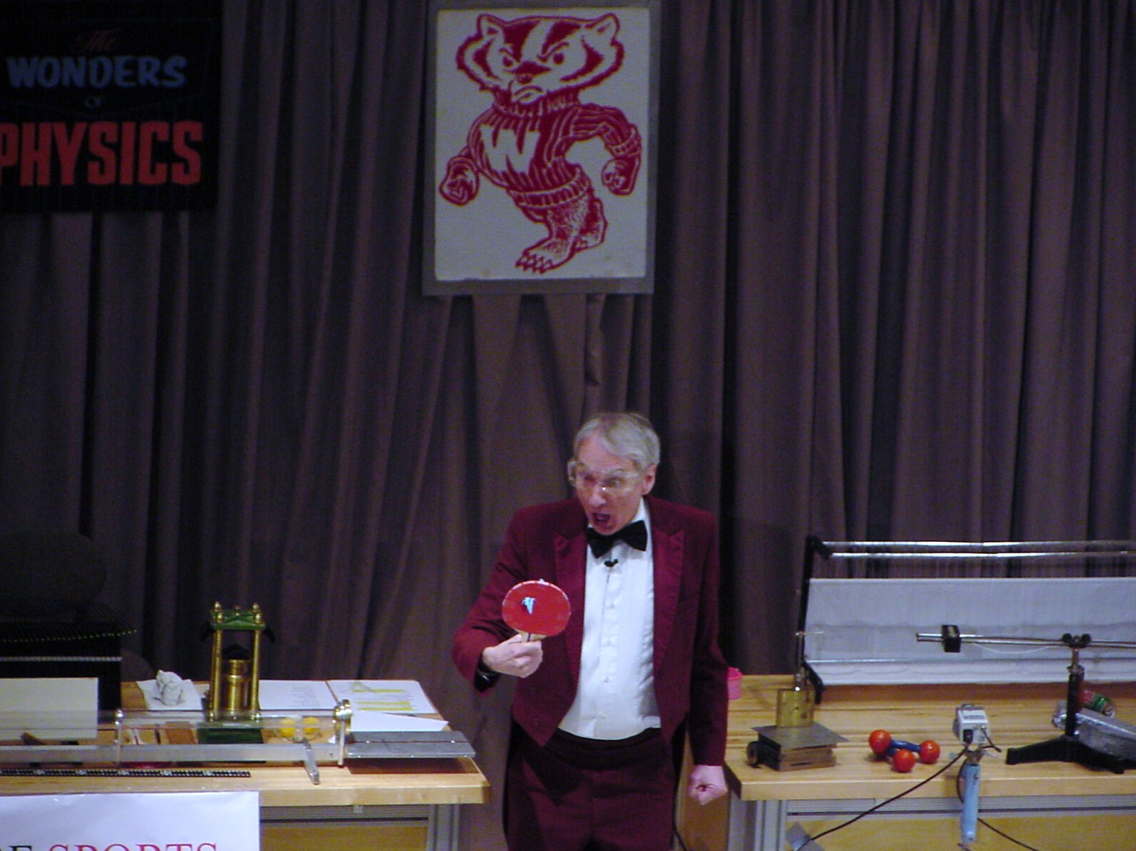 Man on stage doing an experiment