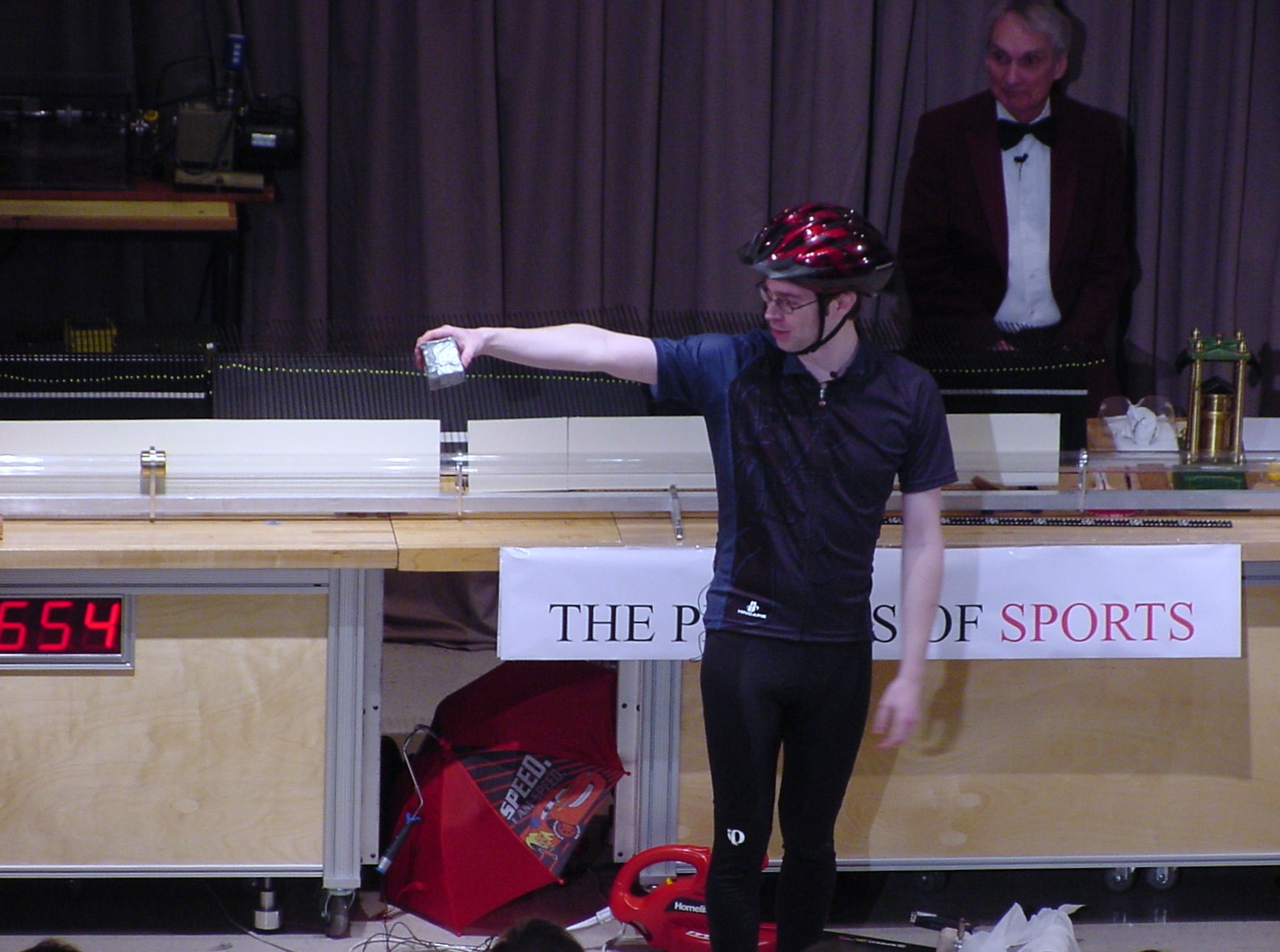 Man on stage doing an experiment