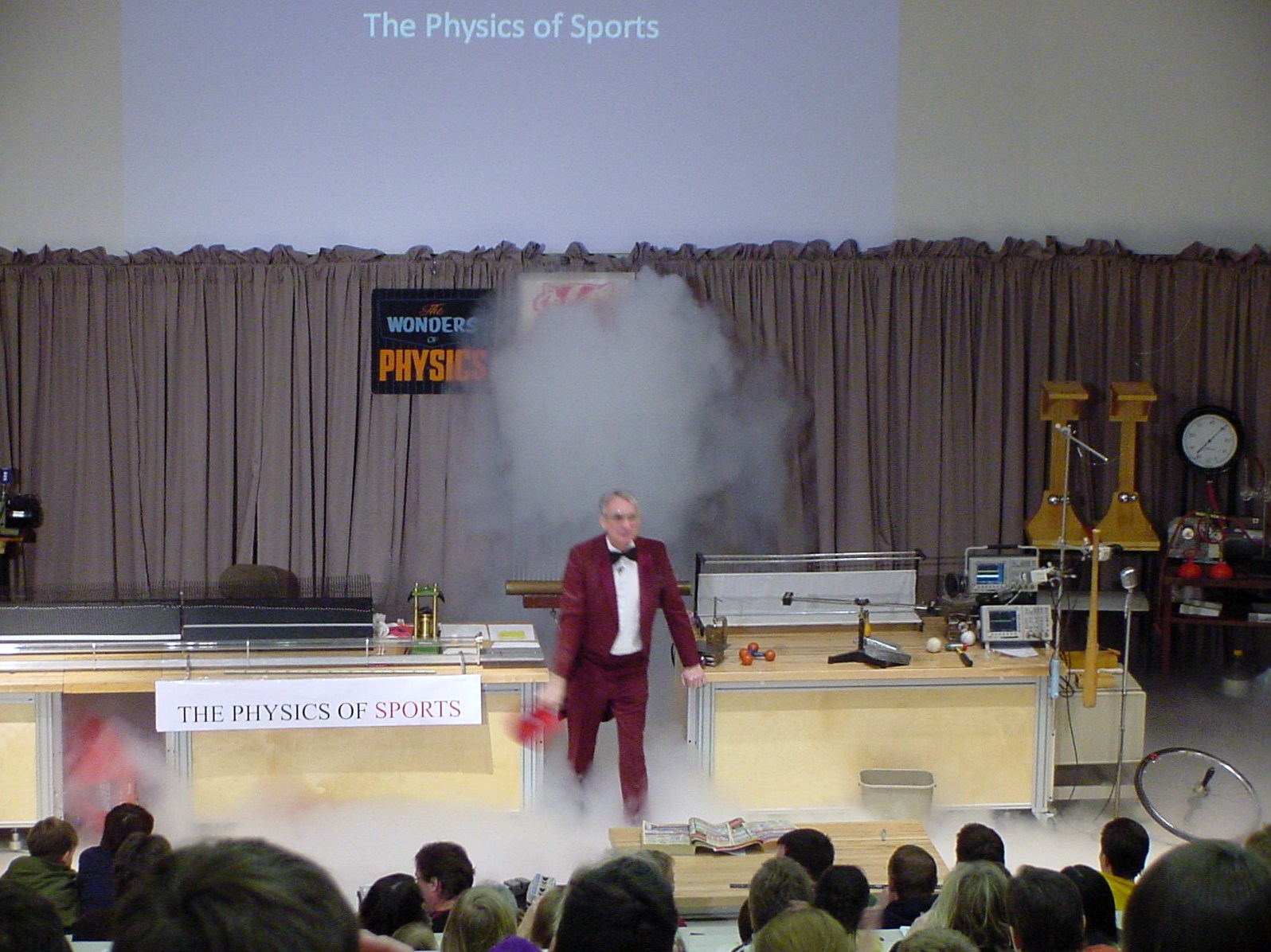 Man on stage doing an experiment