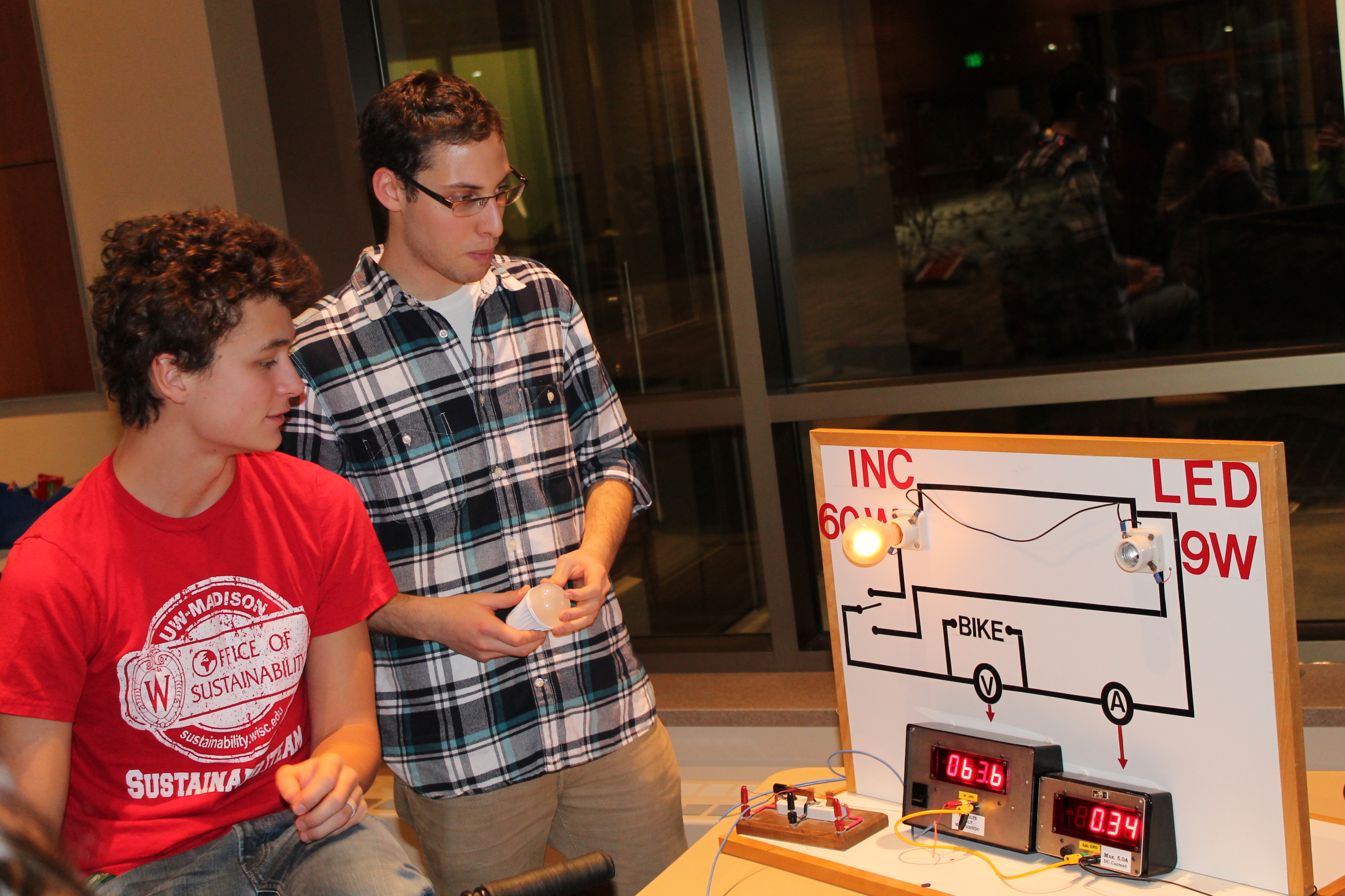 2 boys looking at a drawing