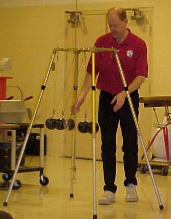 Man demonstrating the Newton Cradle