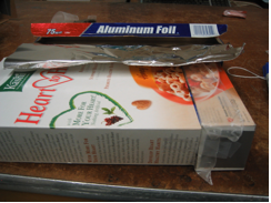 Box with end covered in foil