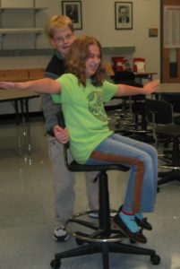 Girl in chair with outstretched arms