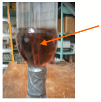 Bottle upside down with duct tape on the top and liquid inside